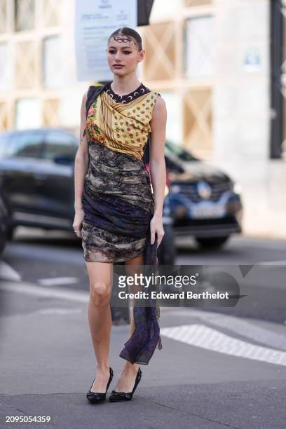 Guest wears a yellow and black draped mini dress, black pumps, outside Marine Serre, during the Womenswear Fall/Winter 2024/2025 as part of Paris...