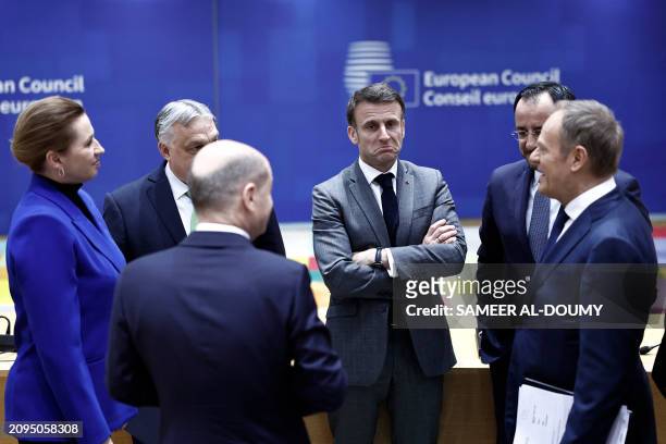 France's President Emmanuel Macron reacts as he speaks with fellow EU leaders before a European Council summit at the EU headquarters in Brussels on...