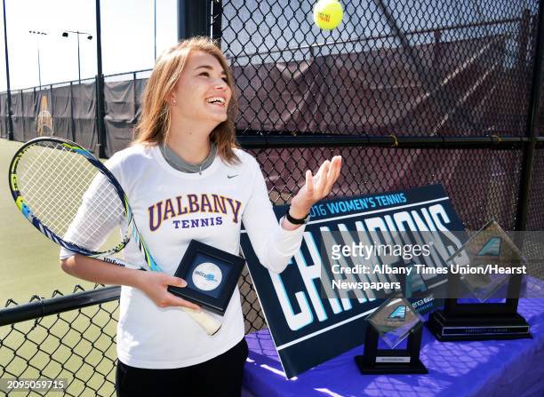 University at Albany tennis team's Mireille Hermans holds her Elite 18 academic award during their "fan appreciation" celebration after qualifying...