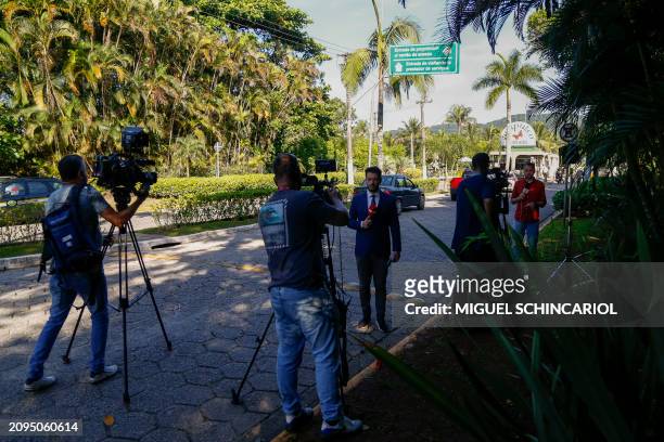 Members of the media work at the entrance of the Acapulco Condominium, the house of the Brazilian former football player Robinho, in Guaruja City, on...