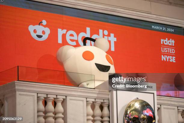 Snoo, mascot of Reddit Inc., rings the opening bell during the company's initial public offering on the floor of the New York Stock Exchange in New...