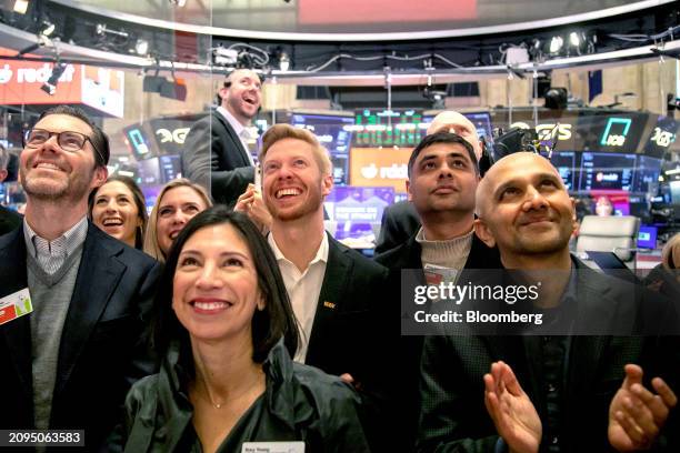 Steve Huffman, co-founder and chief executive officer of Reddit Inc., center, and guests during the company's initial public offering on the floor of...