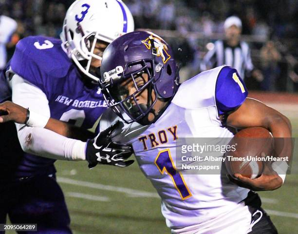 Troy's Joey Ward breaks away from New Rochelle's Myles Taylor during their Class AA state semifinal game at Dietz Stadium Saturday Nov. 19, 2016 in...