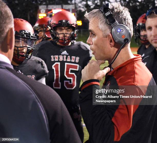 Glens Falls head coach Patrick Lilac with players during a time out in their Class B state semifinal football game against Pleasantville at Dietz...