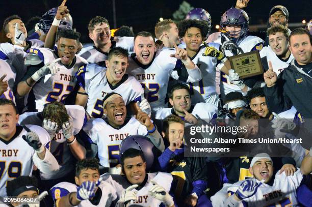 Troy High players pose photos after winning the Class AA state semifinal game against New Rochelle at Dietz Stadium Saturday Nov. 19, 2016 in...