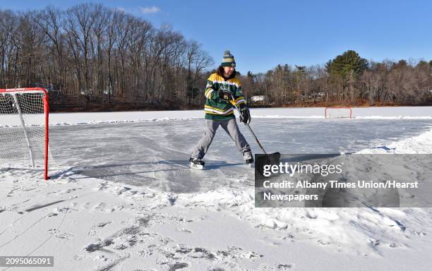 Thomas Osborn of Clifton Park clears off a hockey rink on frozen Barney Road pond Friday Jan. 6, 2017 in Clifton Park, NY.