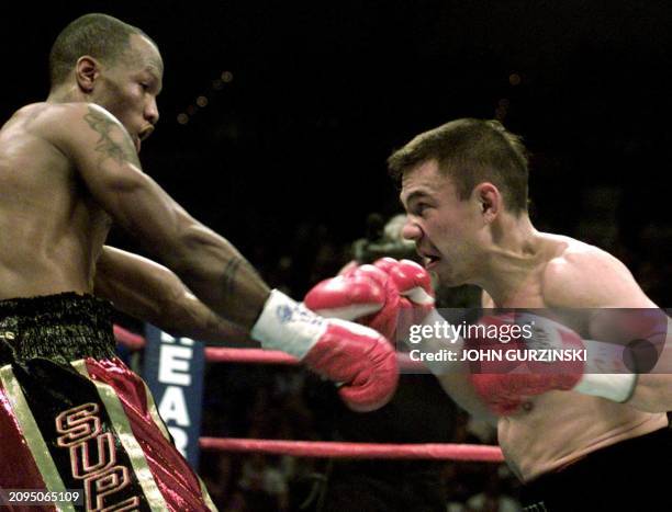 Super Lightweight Champion Kostya Tszyu of Sydney, Australia , backs up IBF Junior Welterweight Champion Zab Judah, of Brooklyn, NY, in the second...