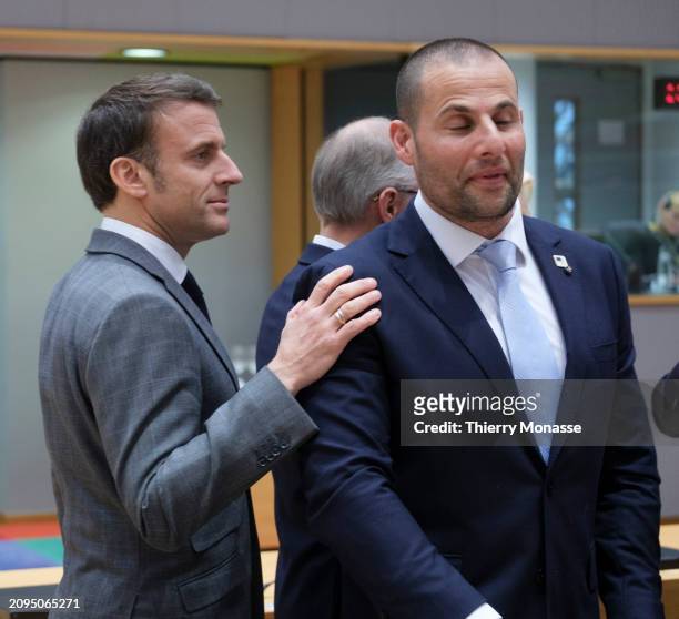 French President Emmanuel Macron greets the Maltese Prime Minister Robert Abela prior the start of an EU Leaders meeting in the Europa building, the...