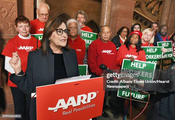 New York State Director Beth Finkel, at podium, speaks during a news conference as AARP delivers 10,000 postcards to state legislative leaders and...