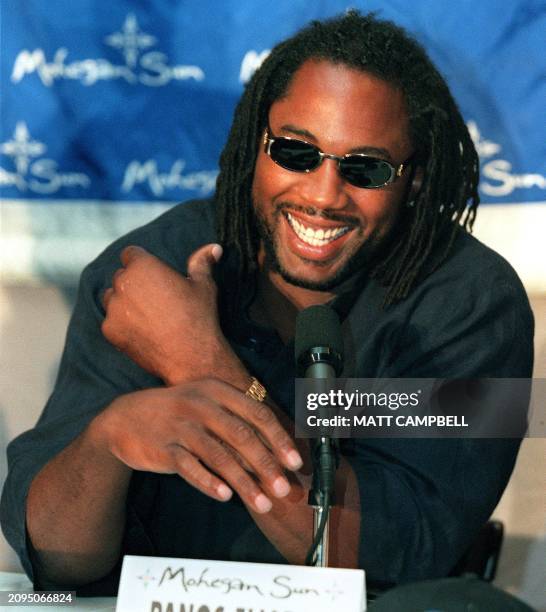 Heavyweight champion Lennox Lewis of Great Britain speaks to the media during a press conference 27 July at Gallagher's Steak House in New York City....