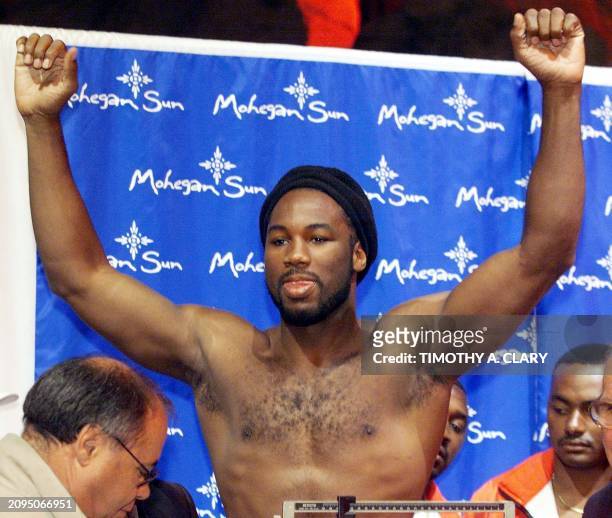 Heavyweight champion Lennox Lewis of England holds his arms up after his weigh-in 25 September at the Mohegan Sun Casino in Uncasville, CT. Lewis,who...
