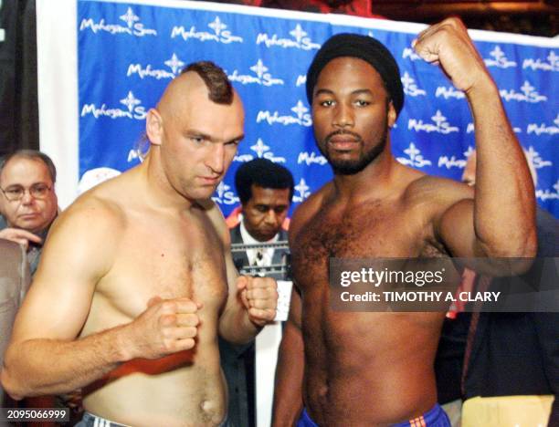 Heavyweight champion Lennox Lewis of England poses with WBC number one contender Zeljko Mavrovic of Croatia after their weigh-in 25 September at the...