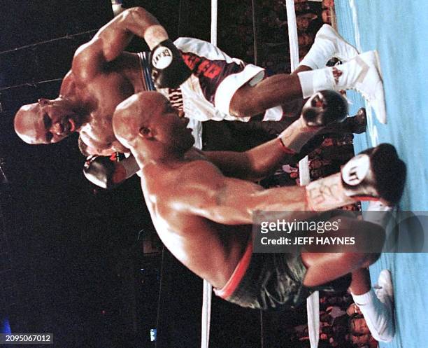 Evander Holyfield knocks down Michael Moorer in the seventh round of their WBA/IBF Heavyweight Championship Unification fight 08 November in Las...