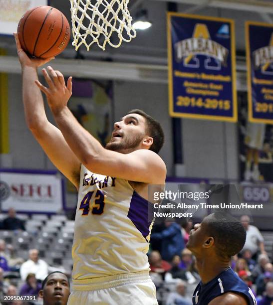 UAlbany's Greig Stire, left, goes to the basket during their CIT Tournament game against Saint Peter's Thursday March 16, 2017 in Albany, NY.