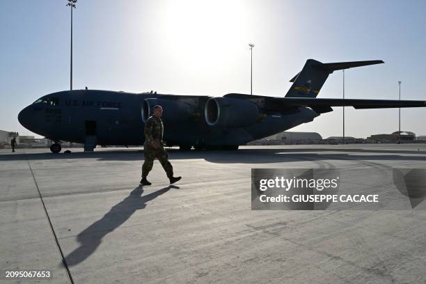 Military transport aircraft, which will carry humanitarian aid parcels for the Gaza Strip, is pictured on the tarmac at the Al-Udeid air base...