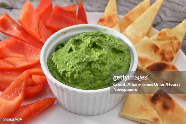 Avocado, kale and lemon pesto served with red peppers and toast points at Caroline Barrrett's home Thursday April 20, 2017 in Delmar, NY.