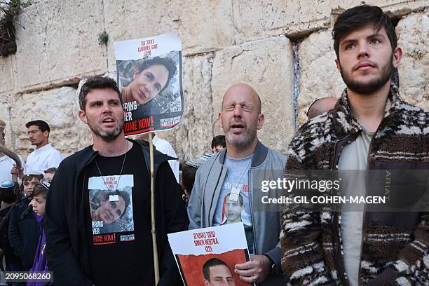 Israelis attend a mass prayer calling for the release of Israeli hostages held in Gaza since the October 7 attacks by Palestinian militants, at the...