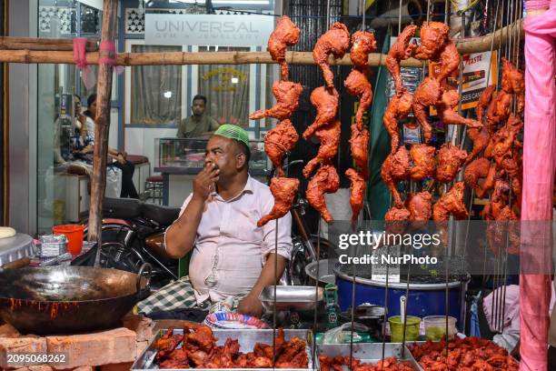 Shopkeeper is selling barbecue chicken legs in front of a mosque in Kolkata, India, on March 21 ahead of iftar time.