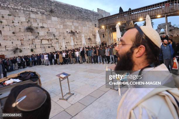 Israelis attend a mass prayer calling for the release of Israeli hostages held in Gaza since the October 7 attacks by Palestinian militants, at the...