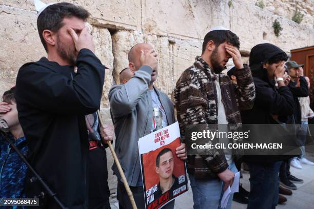 Israelis attend a mass prayer calling for the release of Israeli hostages held in Gaza since the October 7 attacks by Palestinian militants, at the...