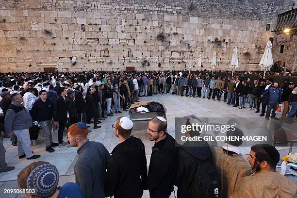 Israelis attend a mass prayer calling for the release of Israeli hostages held in Gaza since the October 7 attacks by Palestinian militants, at the...