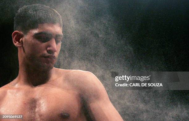 British Amir Khan is sprayed with water before his International Lightweight boxing bout against French Mohammed Medjadji at the Wembley Arena,...