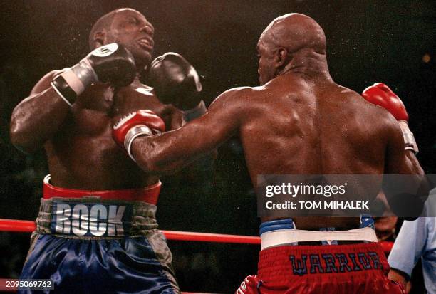 Hasim Rahman recoils from a left hook by Evander Holyfield in the seventh round of their heavyweight bout 01 June 2002 at Boardwalk Hall in Atlantic...