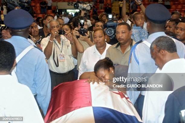 The sister of young boxer Pedro "el Rockero" Alcazar cries on his coffin at the Roberto "Mano de Piedra" Duran gym in Panama City, 29 June, 2002....