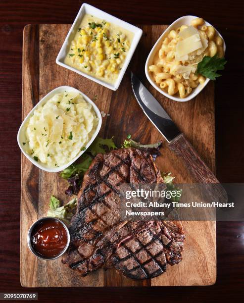 The 28 ounce Porter House with parmesan risotto, mac and cheese, creamed corn and their signature steak sauce at Rare, a Union Street restaurant...