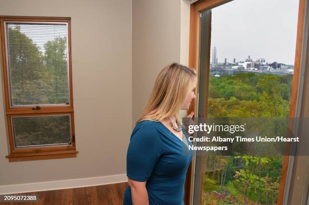 Renssealer County Chamber of Commerce's Staci O'Neill checks out the view of the Albany skyline during a tour of the new luxury Falls Edge Apartments...