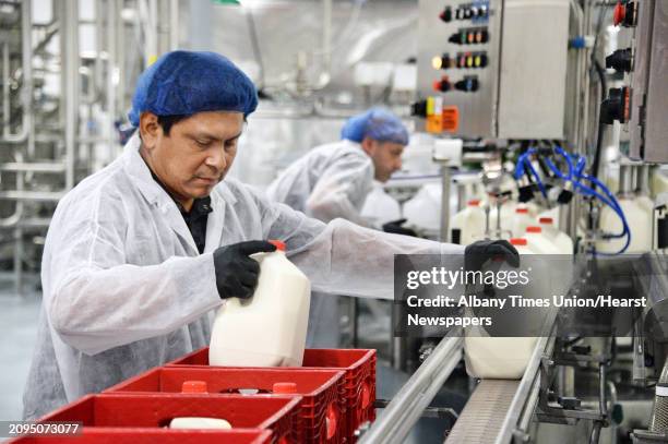 Dairy worker Jorge Velasco crates whole milk being bottled at King Brothers Dairy's new bottling plant Wednesday Sept. 20, 2017 in Schuylerville, NY.