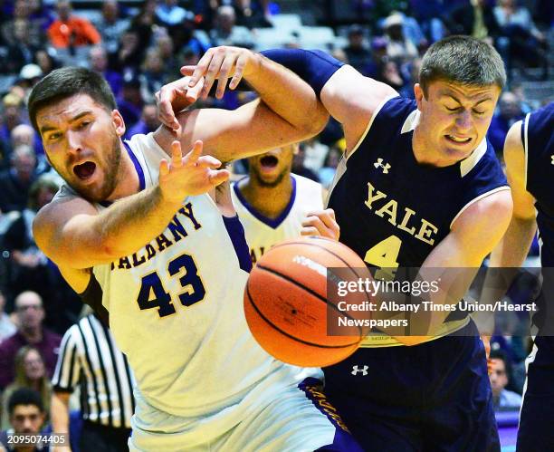 UAlbany's Greig Stire, left, tangles with Yale's Noah Yates during Friday night's game Nov. 17, 2017 in Albany, NY.