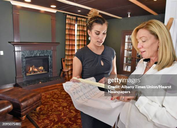 Interior designer Julie Maleski Putzel, left, of JMP Interiors and home owner Laura Lehner review plans for the British library under construction at...