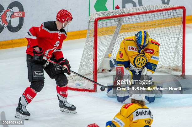 Jiri Sekac of Lausanne HC tries to score against Goalie Sandro Aeschlimann of HC Davos during the Swiss National League Play Offs game between...