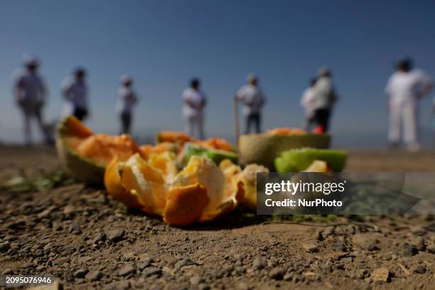 Group of people is visiting the archaeological site of Cerro de la Estrella in Mexico City, where they are performing various rituals, meditating,...