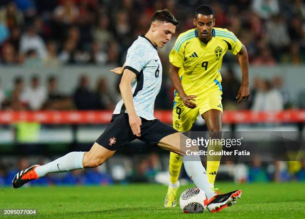 Joao Palhinha of Portugal with Alexander Isak of Sweden in action during the International Friendly match between Portugal and Sweden at Estadio D....