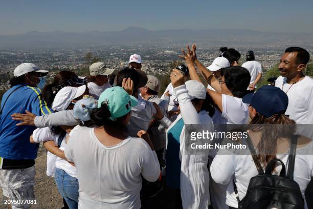 Group of people is visiting the archaeological site of Cerro de la Estrella in Mexico City, where they are performing various rituals, meditating,...
