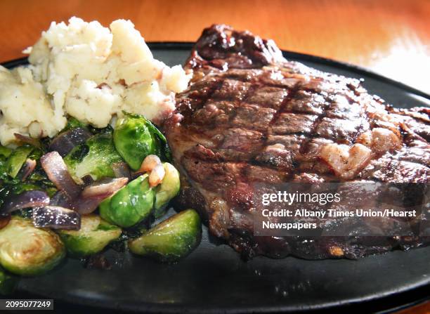 Delmonico steak with Brussels sprouts and signature mashed potatoes at The Cock 'n Bull restaurant Thursday March 8, 2018 in Galway, NY.