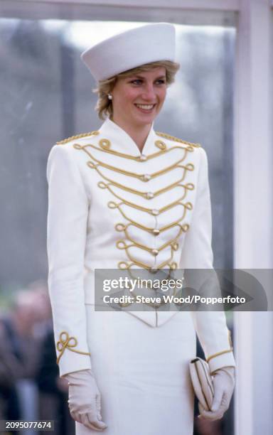 Princess Diana wearing a white military suit with gold majorette drum frogging and epaulettes designed by Catherine Walker during a visit to the...