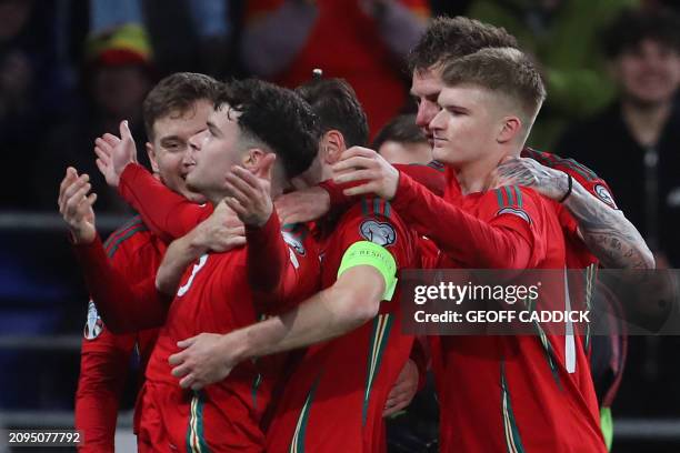 Wales' defender Neco Williams celebrates with teammates after scoring their second goal during the UEFA Euro 2024 playoff semi-final football match...