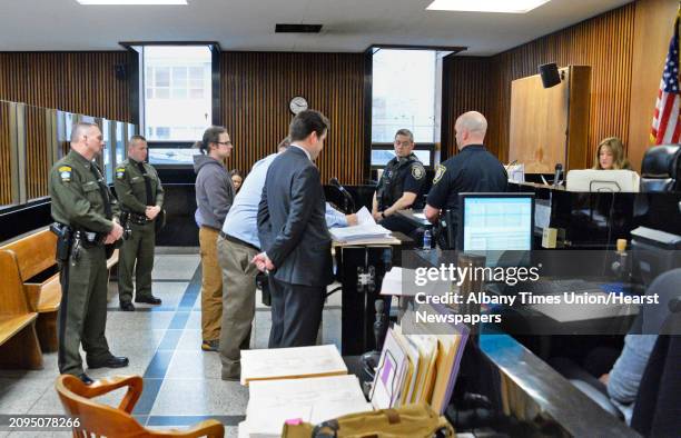 Town of Bolton's chief operator of its water department Thomas French II, center in hoodie, is arraigned before Judge Holly Trexler, right, in Albany...