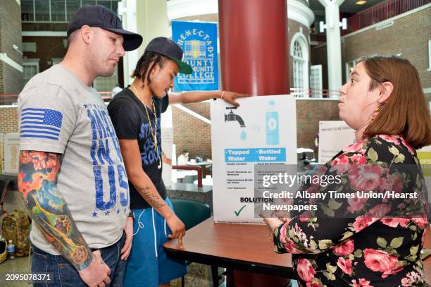 Environmental science classmates John Kent, left, Tyrique Hagood and Brittney Armstrong discuss Armstrong's presentation during Schenectady County...