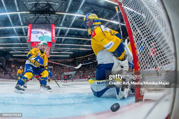 Jiri Sekac of Lausanne HC scores a goal against Goalie Sandro Aeschlimann of HC Davos during the Swiss National League Play Offs game between...