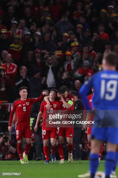 Wales' midfielder Daniel James celebrates with teammates after scoring their fourth goal during the UEFA Euro 2024 playoff semi-final football match...