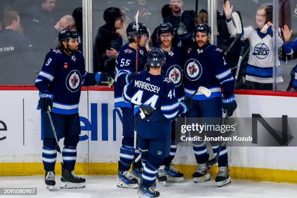 Kyle Connor, Dylan DeMelo, Mark Scheifele, Josh Morrissey, and Alex Iafallo of the Winnipeg Jets celebrate a first period goal against the Anaheim...