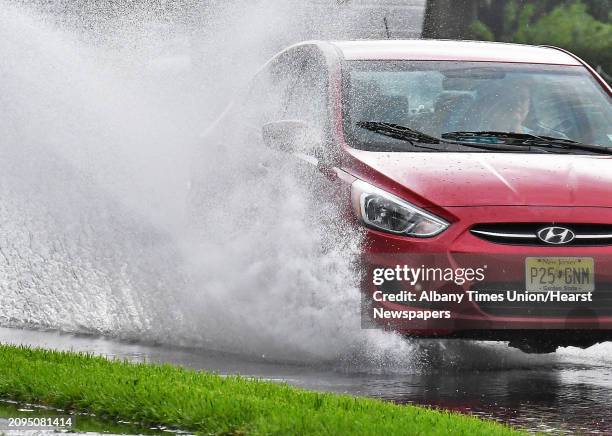 Motorist splashes through a puddle along Wolf Road on a rainy Wednesday afternoon July 25, 2018 in Colonie, NY.