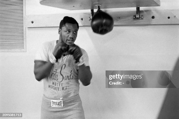 Picture taken in January 1973 of US heavyweight boxing champion Joe Frazier during a training in Kingston before his match against George Foreman.Joe...