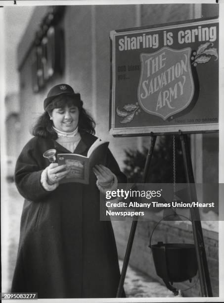 Northway Mall, Colonie, New York - Salvation Army kettle bell ringer Gina Sutera in front of Montgomery Wards Thursday afternoon. December 15, 1988