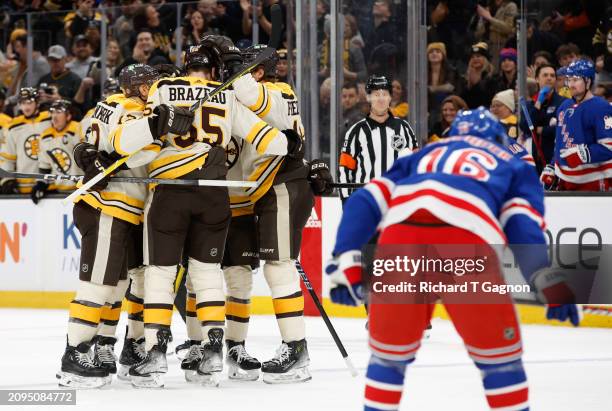 Jake DeBrusk of the Boston Bruins celebrates his goal against the New York Rangers with teammates Kevin Shattenkirk, Justin Brazeau, Trent Frederic...