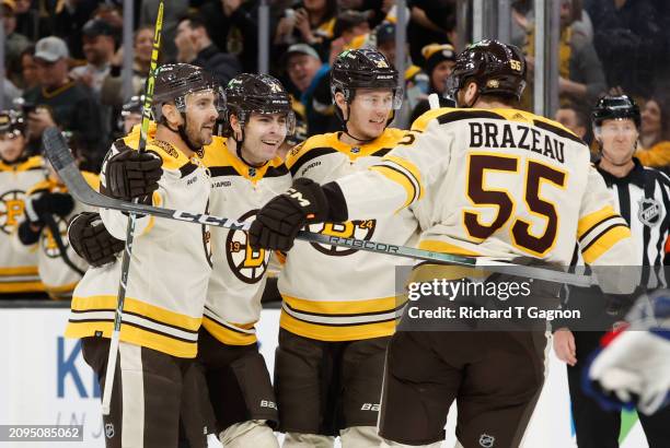 Jake DeBrusk of the Boston Bruins celebrates his goal against the New York Rangers with teammates Kevin Shattenkirk, Justin Brazeau and Morgan Geekie...